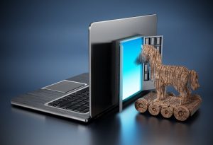 Trojan horse entering door on laptop computer.